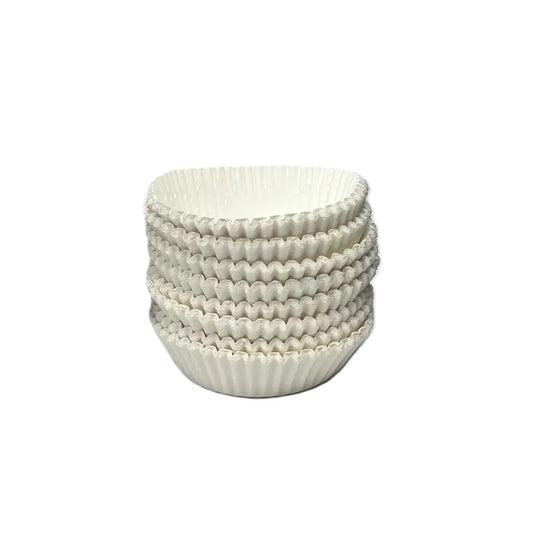 Stack of white fluted candy cups with ridged accordion sides, shown nested together on a white background.