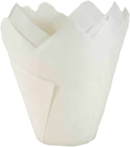 White tulip cupcake liner with a pointed, petal-like design, made from parchment paper.