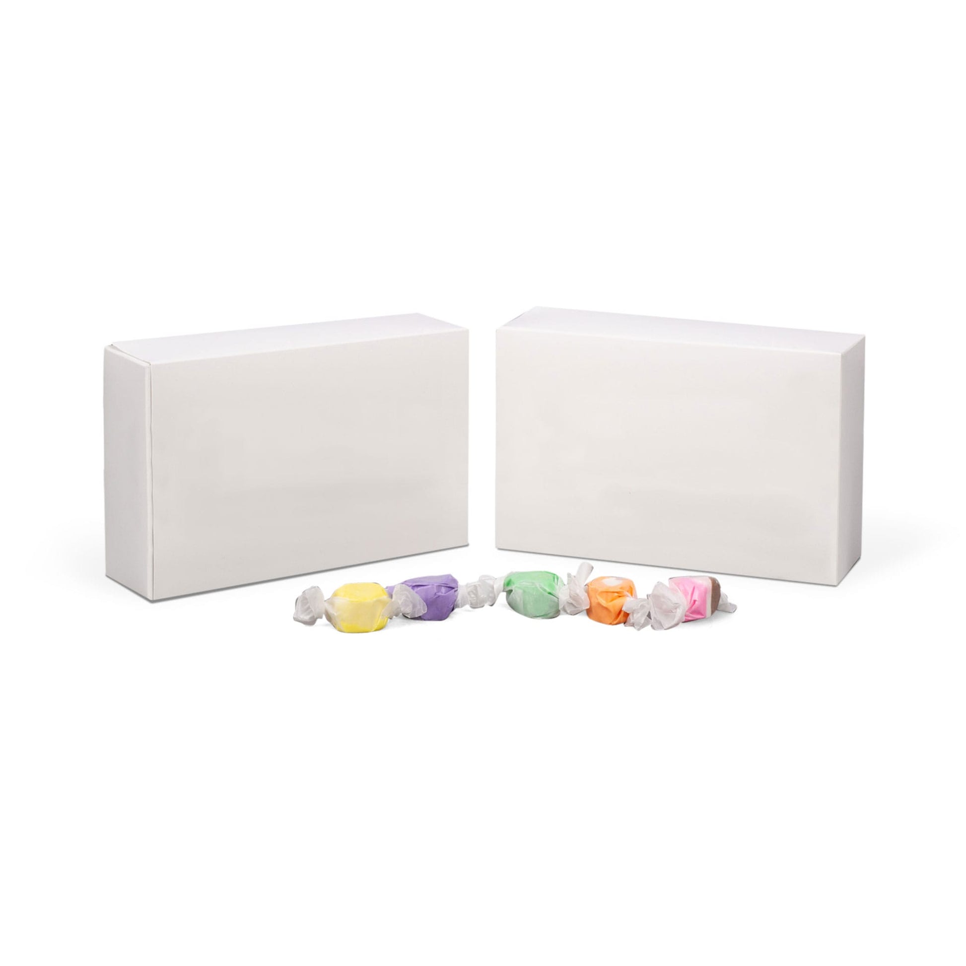 White 1 1/2 lb candy box with assorted wrapped candies, perfect for packaging and displaying chocolates or confections.