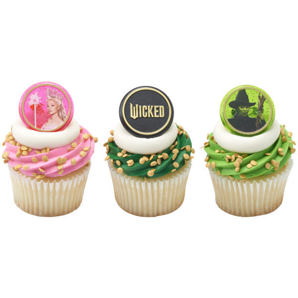 Rectangular green gradient sheet cake with black piped border and scroll accents, topped at center with a black and silver “Make Your Own Magic” plaque; ideal pairing with Wicked rings.