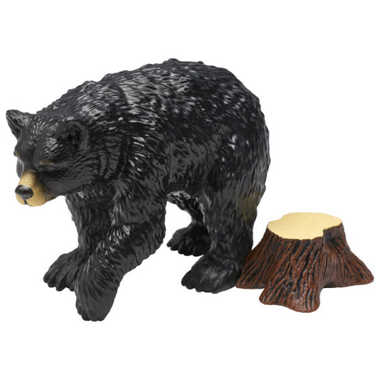 A detailed black bear figurine with a tree stump accessory.