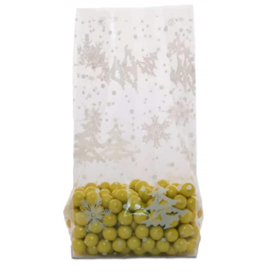 A large cellophane treat bag partially filled with yellow round candies. The visible section of the bag displays a frosted snowflake pattern in white, with varying sizes of snowflakes and dots resembling a gentle snowfall. The snowflake design overlays a translucent background, allowing the yellow candies at the bottom to peek through, giving a sense of a festive winter scene.
