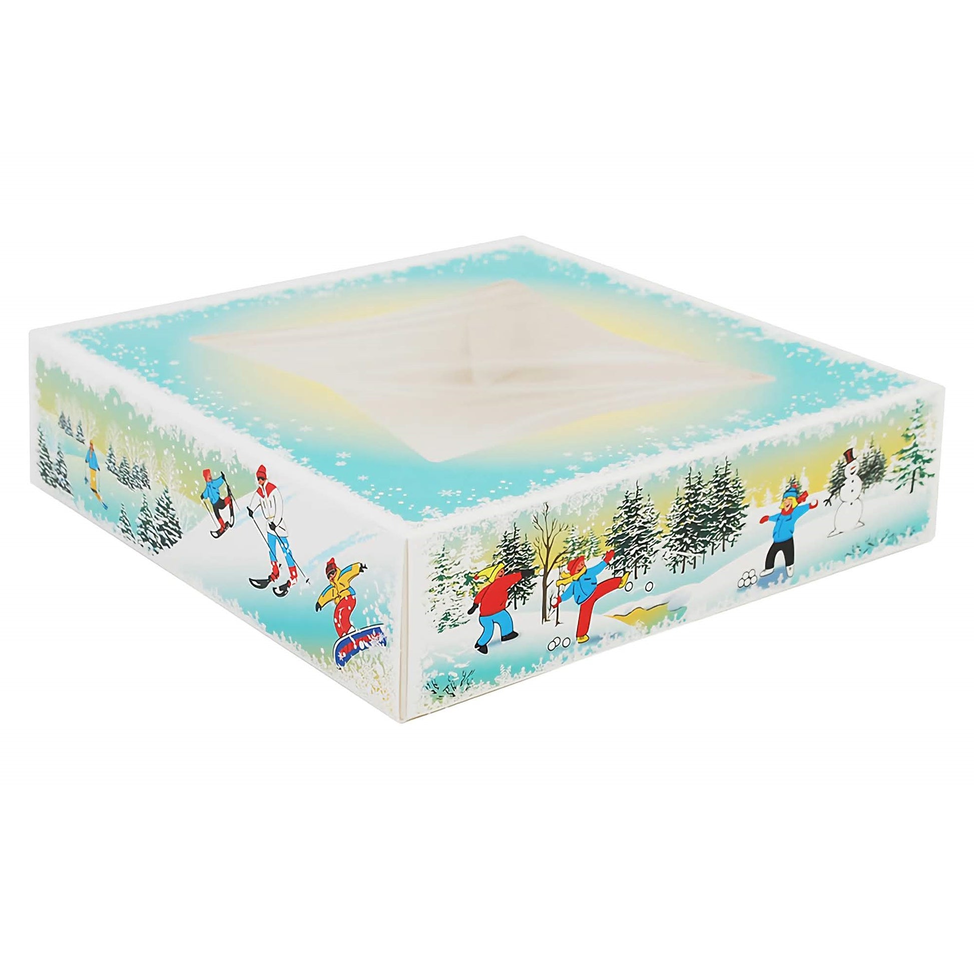 This image features a large Winter Wonderland candy box with a transparent window on the top. The sides of the box are adorned with a festive winter scene that includes people engaging in activities such as skiing and walking dogs, against a backdrop of snow-covered trees and falling snowflakes. The design evokes a cheerful holiday spirit and a sense of snowy adventure.