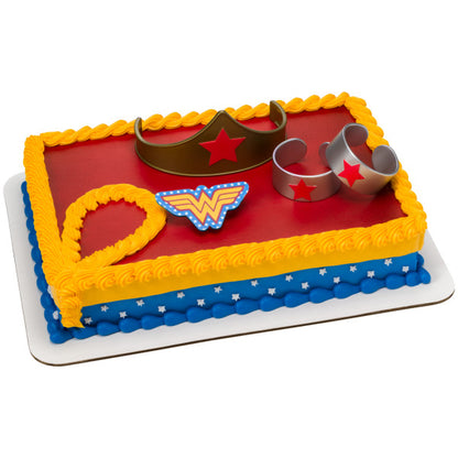 A rectangular cake decorated with the Wonder Woman™ DecoSet®, featuring a red, blue, and gold theme with superhero-inspired elements.