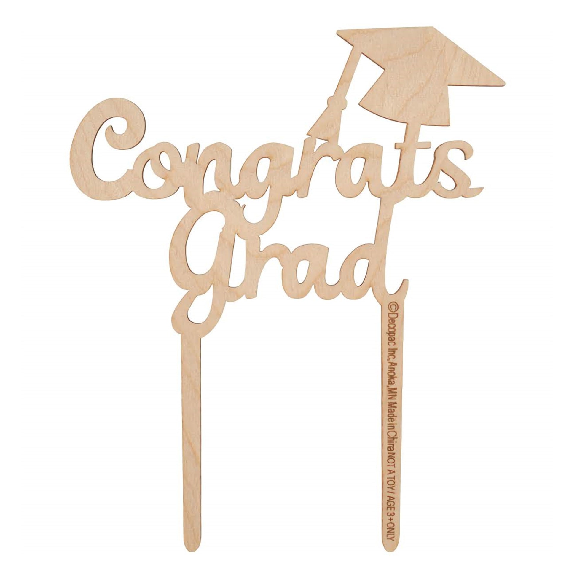 A wooden cake topper pick that reads 'Congrats Grad' in a flowing script, complete with a graduation cap accent, offering a classic and elegant finish for a graduation cake.