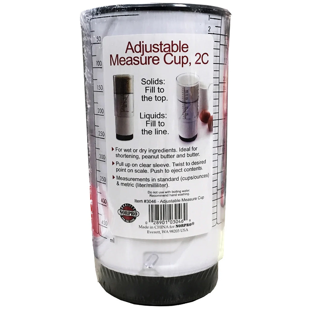 Norpro 2-cup adjustable measuring cup in retail packaging with printed instructions, measurement markings, and product information visible.
