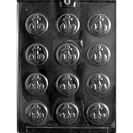 Clear plastic chocolate mold photographed on a dark background with twelve round cavities, each featuring an embossed anchor design in the center.