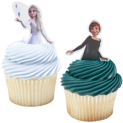 Two cupcakes shown close-up with light blue frosting and an Elsa topper pick, and teal frosting with an Anna topper pick, both in white cupcake liners.