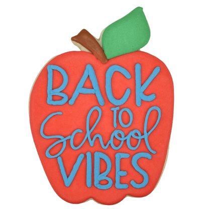 Decorated apple-shaped cookie with "Back to School Vibes" written in blue icing, a green leaf, and a brown stem.