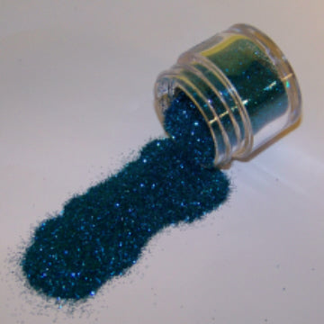 Teal blue Galaxy Glitter Dust poured from a clear jar, rich with oceanic shimmer and deep sapphire sparkle.