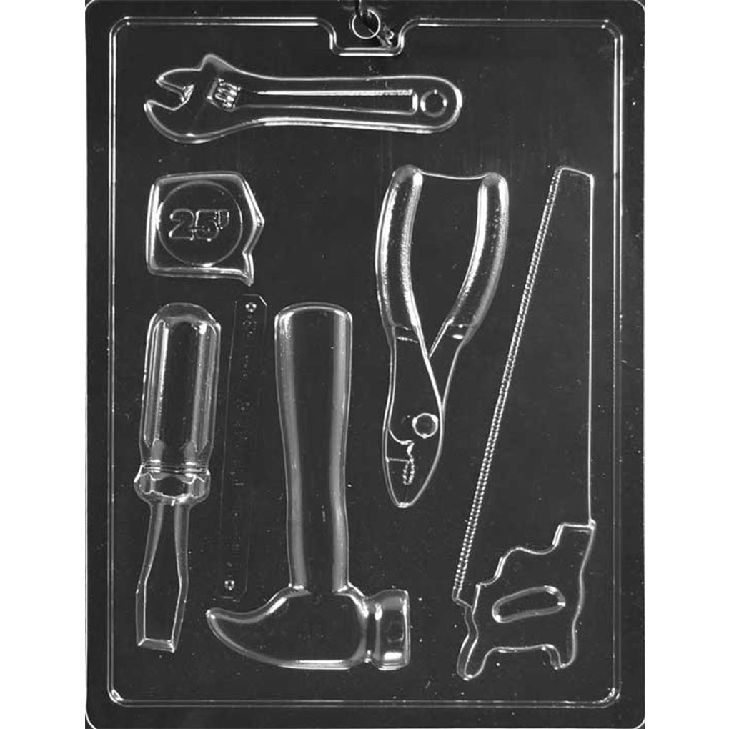 Clear plastic chocolate mold with assorted tool shapes including a wrench, tape measure, pliers, screwdriver, hammer, and saw.