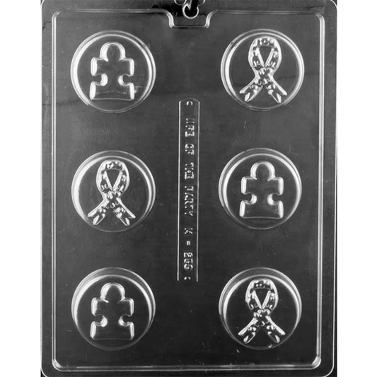 Plastic mold tray with six round cavities featuring embossed puzzle piece and awareness ribbon designs for chocolate-covered cookies.