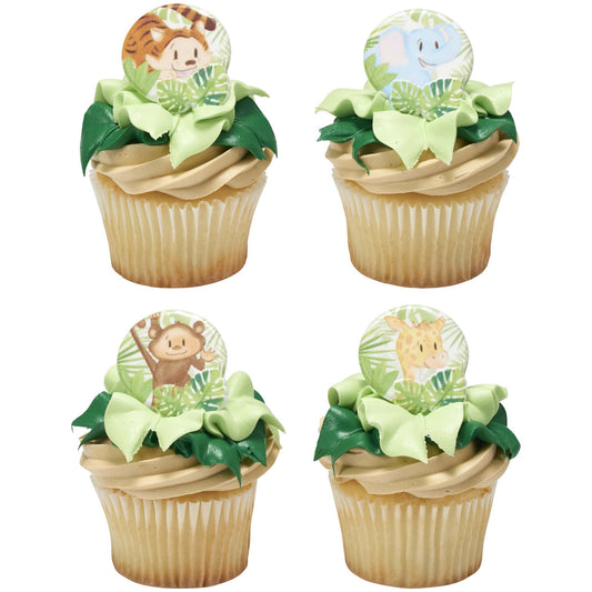 Four jungle-themed cupcakes with green leaf frosting topped with baby tiger, elephant, monkey, and giraffe cupcake rings