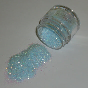  Light baby blue Galaxy Glitter Dust spilled from a clear jar, featuring soft shimmer with hints of pink and gold.