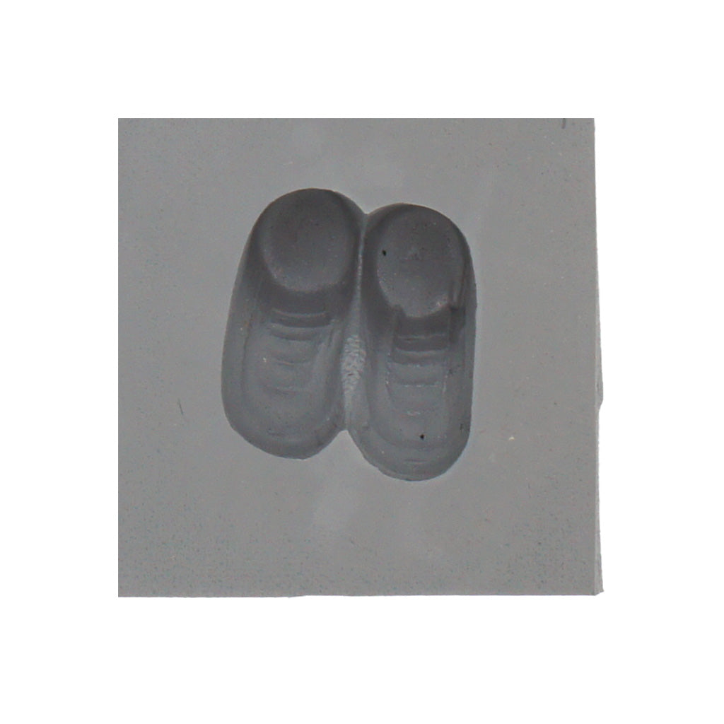 Close-up of a single cavity Baby Booties Rubber Mint Mold made from gray 100% natural rubber, showing defined baby shoe details like soles and laces.