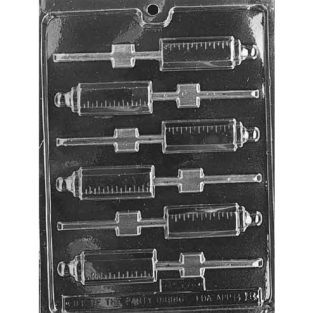 Clear plastic baby bottle chocolate lollipop mold photographed on a black background, showing six bottle-shaped cavities with measurement lines and built-in stick grooves.