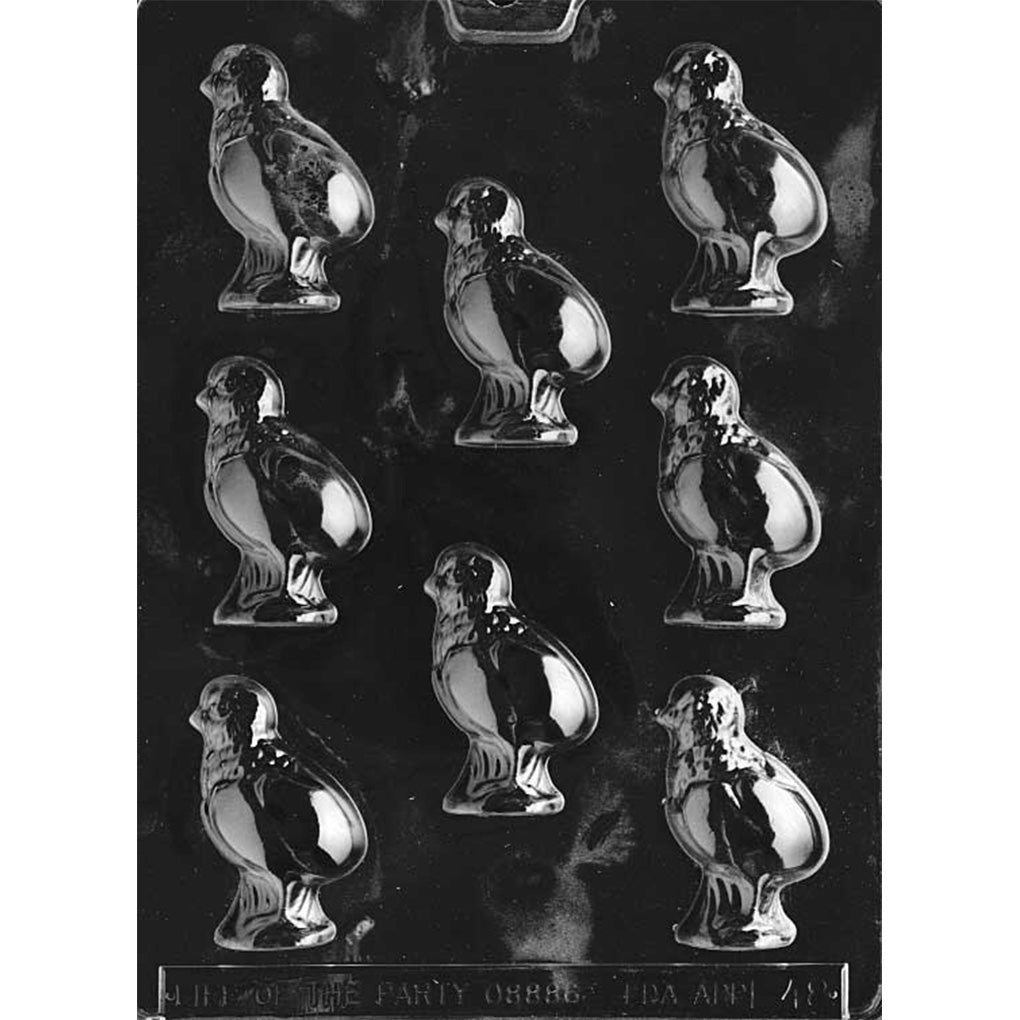 Clear plastic chocolate mold with multiple baby chick cavities, each showing a standing chick figure with rounded body and wing detail, arranged in a grid on a dark background.
