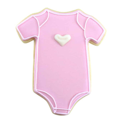 Pink baby onesie cookie decorated with a white heart and piped icing details.