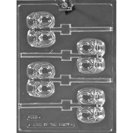 Clear plastic chocolate lollipop mold with four baby shoe cavities featuring raised laces and soles, plus stick channels for making baby shoe chocolate pops.