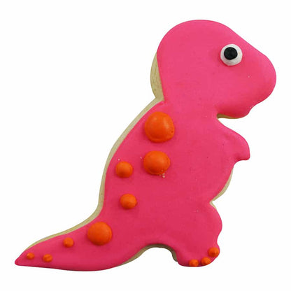 Decorated baby T-Rex cookie with pink icing, orange spots, and a single black-and-white eye.