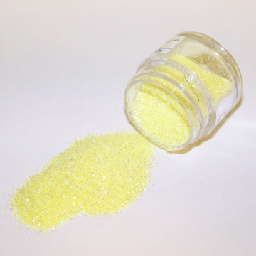 Light yellow Galaxy Glitter Dust pouring from a jar, radiating a cheerful lemony shimmer with fine iridescent sparkle.