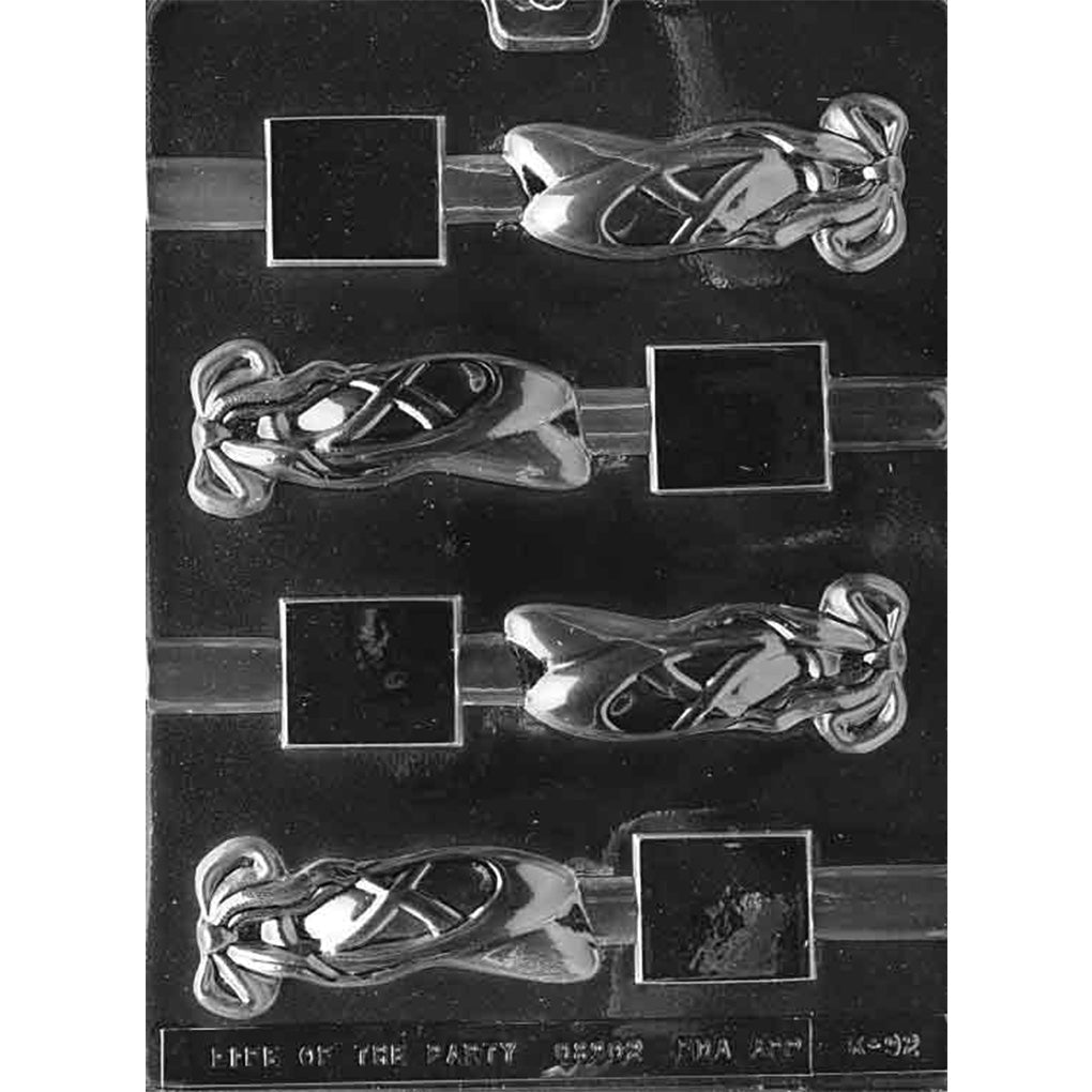 Clear plastic pretzel rod chocolate mold with 4 cavities featuring paired ballet slippers, crisscrossed ribbons, tied bows, and rod channels.