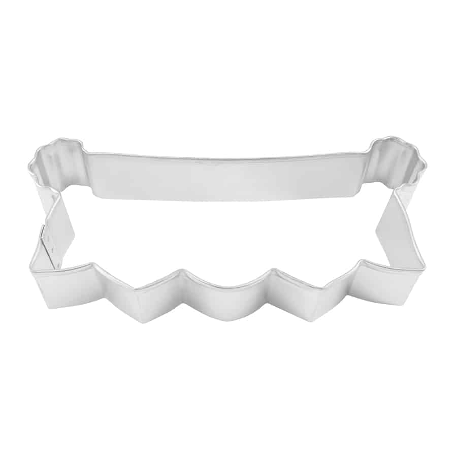 Metal banner cookie cutter with a scalloped bottom edge, top-down view.