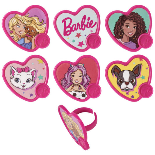 Seven heart-shaped Barbie cupcake rings with bright pink frames, featuring assorted designs including Barbie, friends, pets, stars, and the Barbie logo on a white background.