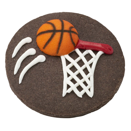 Chocolate cookie decorated like a basketball hoop with white icing net and red rim, topped with an orange pressed sugar basketball decoration.