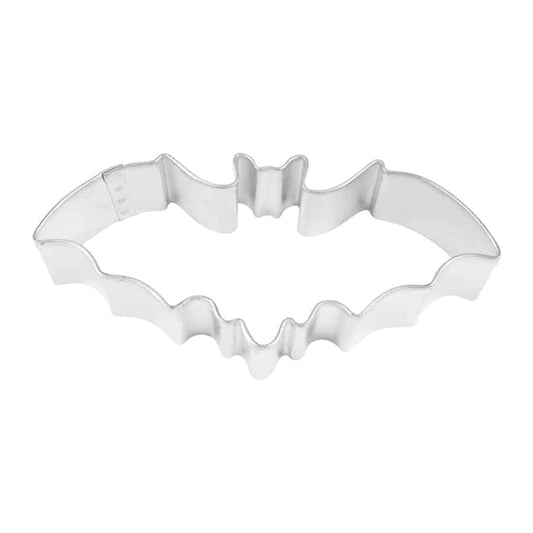 Overhead view of a metal bat-shaped cookie cutter with outstretched wings.