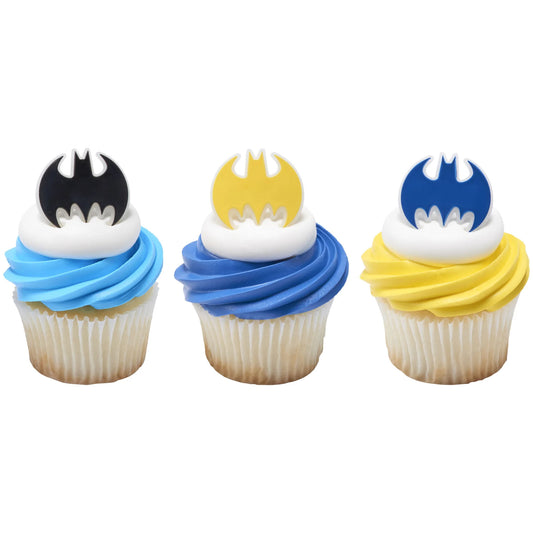 Three cupcakes decorated with Batman bat emblem rings in black, yellow, and blue, set into white frosting over blue and yellow swirled icing.