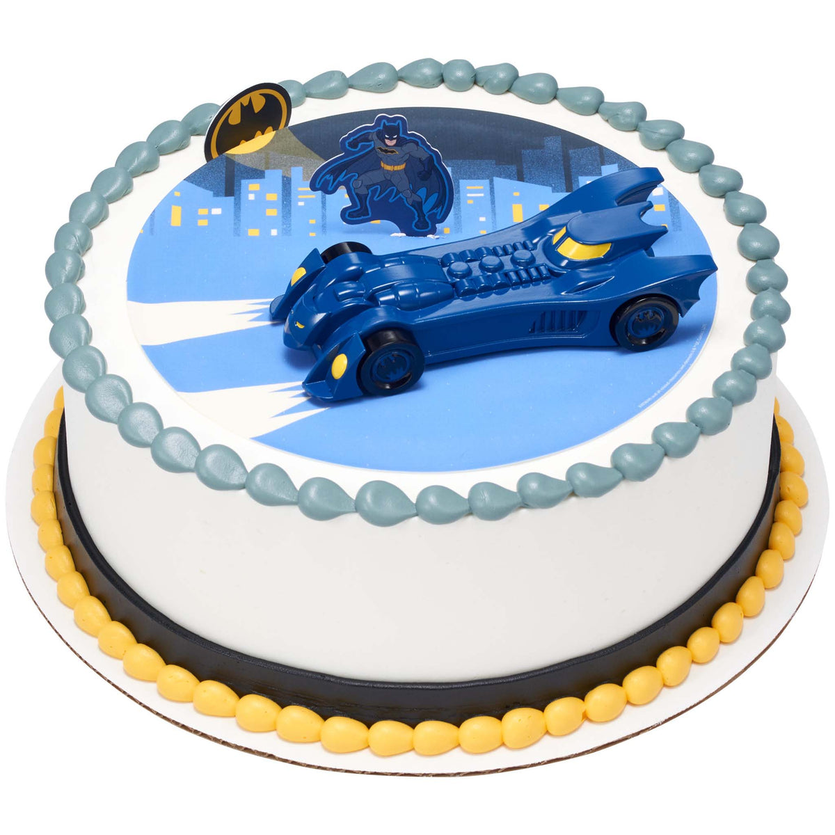 Round Batman cake with a printed blue Gotham city scene, Batman figure, Bat-Signal emblem, and large blue Batmobile centered on top.