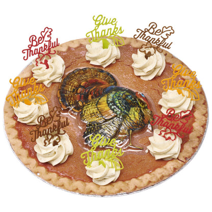 Pumpkin pie with whipped topping, decorated using multiple Thanksgiving picks and a colorful turkey cake image.