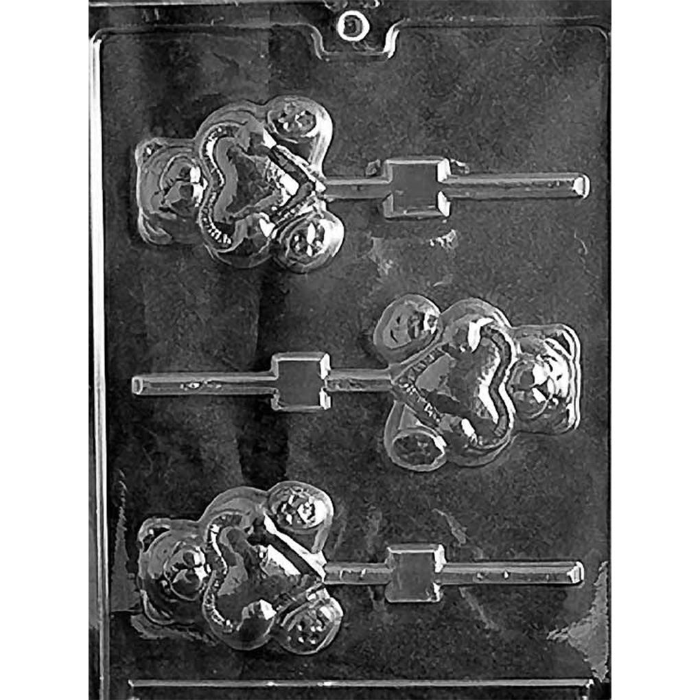 Clear plastic chocolate lollipop mold with three teddy bear cavities, each bear holding a heart with embossed details and a stick channel, on a dark background.