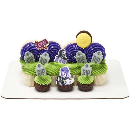 BEETLEJUICE cupcake rings arranged on a Halloween cupcake display with purple and green frosting and tombstone decorations