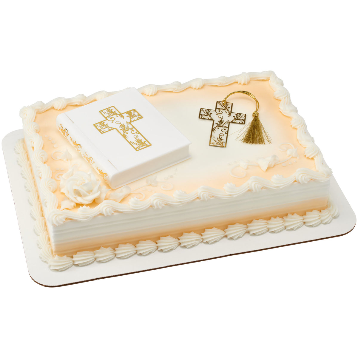 White Bible cake topper and gold cross bookmark arranged on an ivory sheet cake with piped borders and gold accents.