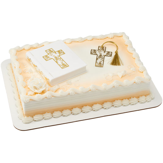 White Bible cake topper and gold cross bookmark arranged on an ivory sheet cake with piped borders and gold accents.