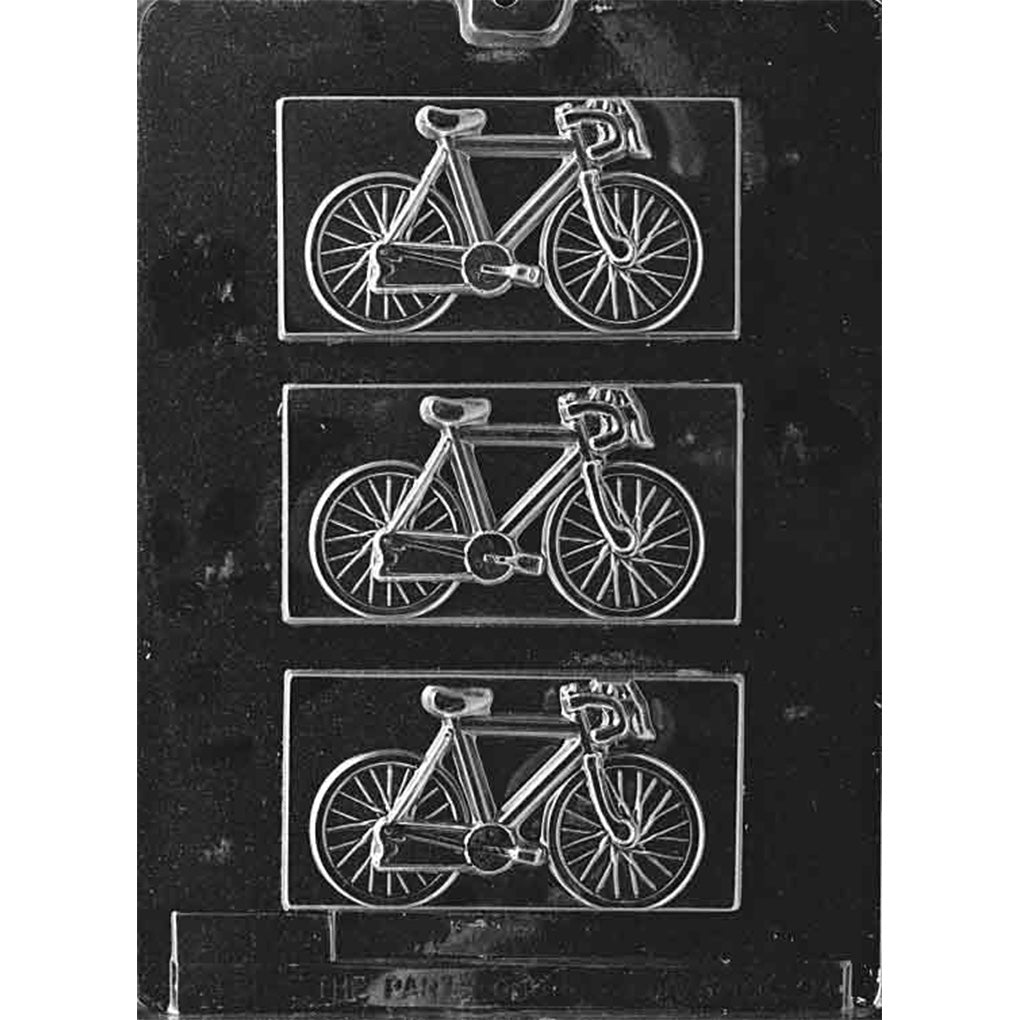 Clear chocolate mold with three rectangular plaque cavities, each embossed with a detailed bicycle featuring spoked wheels, a slim frame, handlebars, and pedals on a dark background.