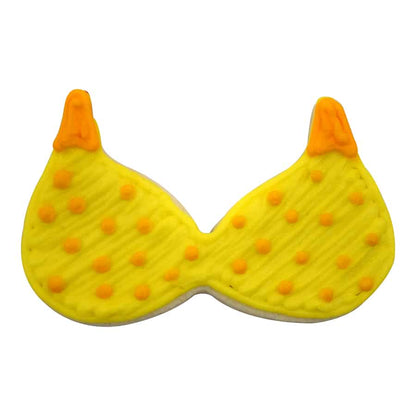 Decorated sugar cookie shaped like a bikini top with yellow icing, orange polka dots, and orange strap details.