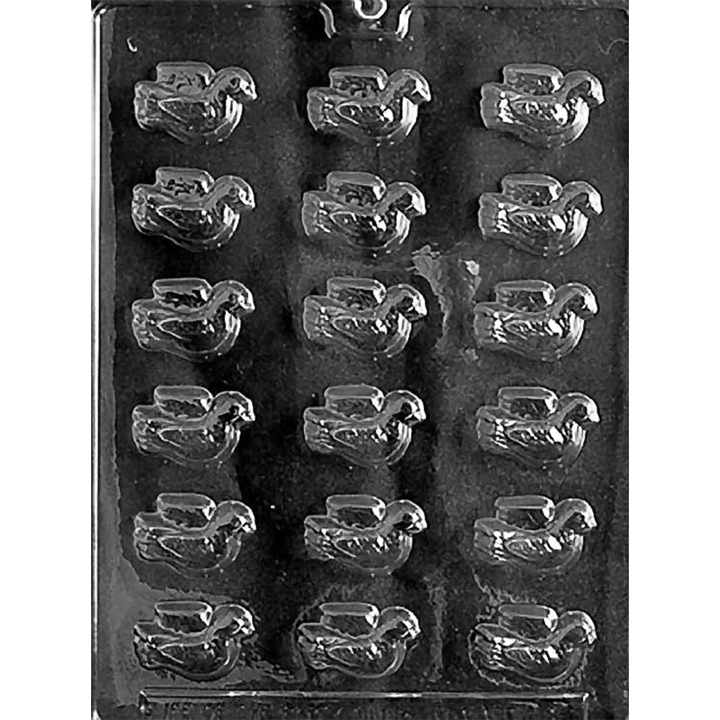 Clear plastic chocolate mold with multiple small dove-shaped cavities arranged in neat rows on a dark background.