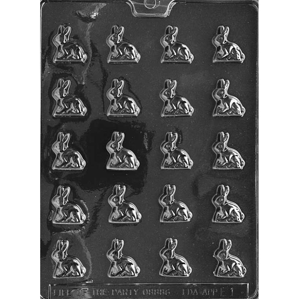 Clear plastic chocolate mold with 20 sitting bunny cavities arranged in a grid, photographed on a black background to highlight the bunny shapes and detail.