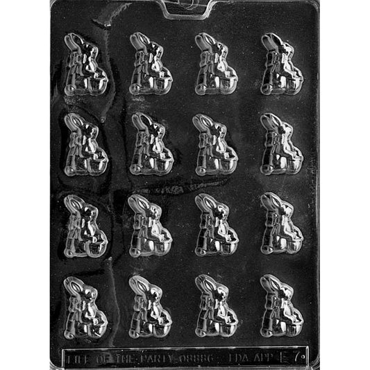 Clear plastic chocolate mold shown on a black background with a 4-by-4 grid of bite-sized cavities shaped like a sitting bunny wearing a bow and holding a basket.