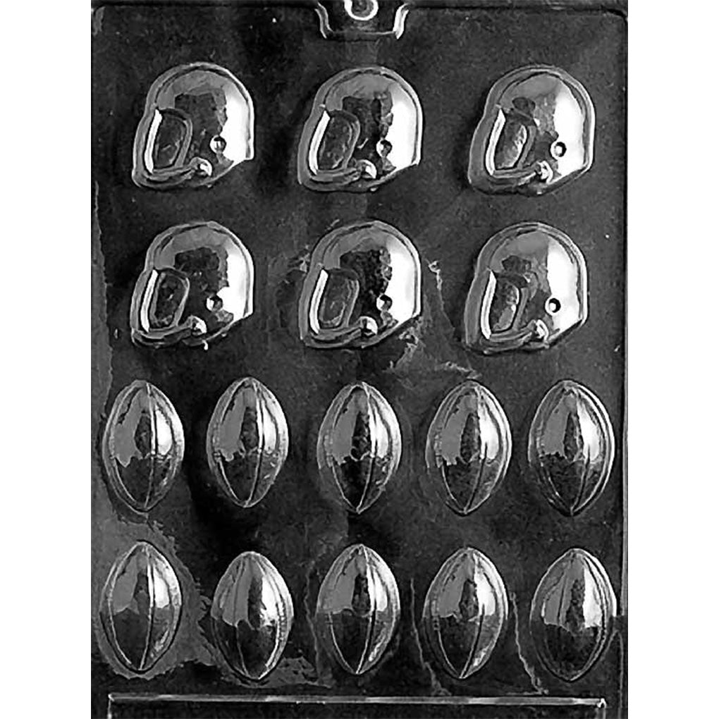 Clear plastic chocolate mold tray showing assorted bite-size football and football helmet cavities with raised details, arranged in rows on a dark background.