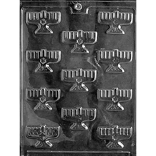 Clear plastic chocolate mold with multiple small menorah-shaped cavities in rows, each showing candle details and a small base.