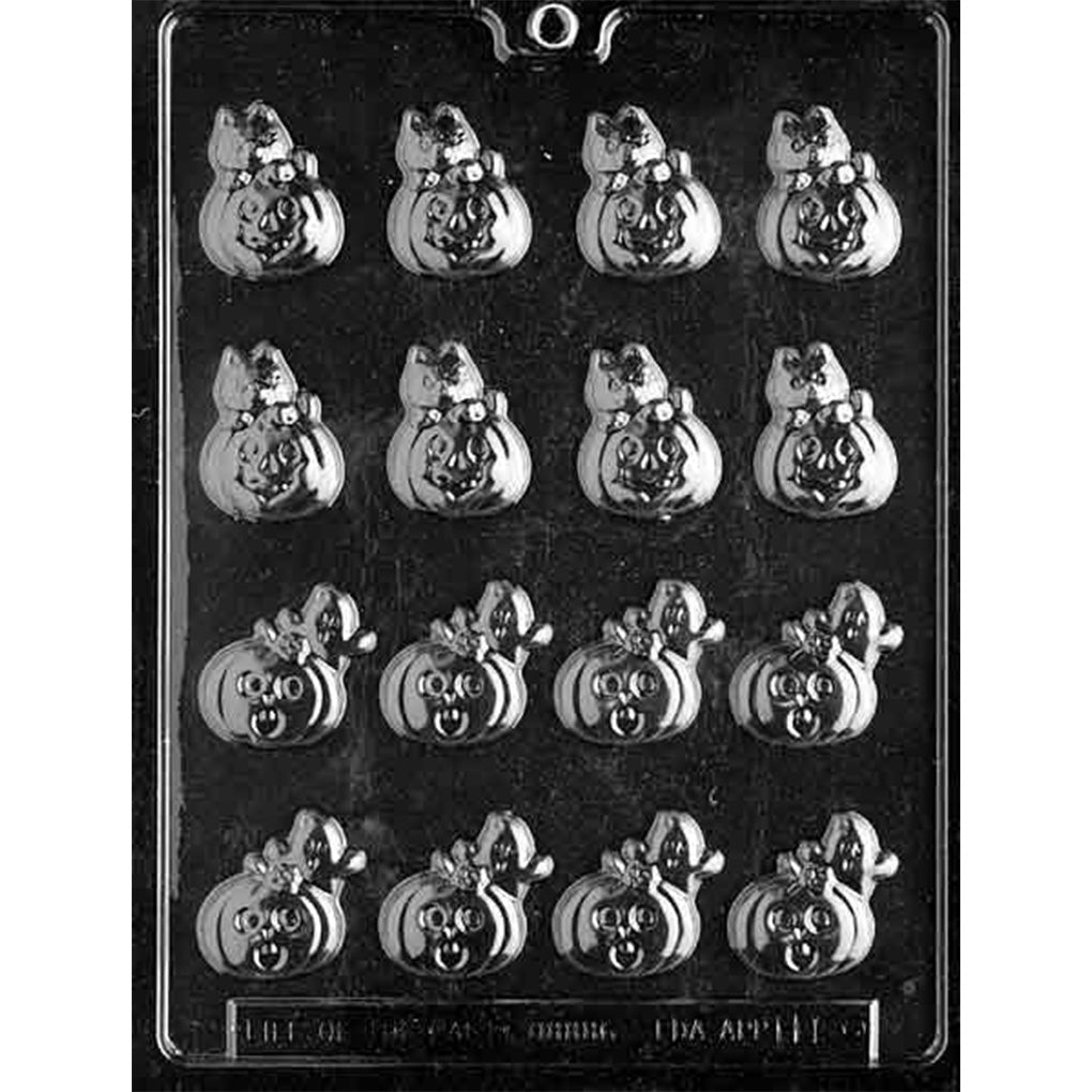 Clear plastic chocolate mold photographed on a dark background with sixteen small pumpkin-shaped cavities in two designs, one topped with a cat and one topped with a ghost.