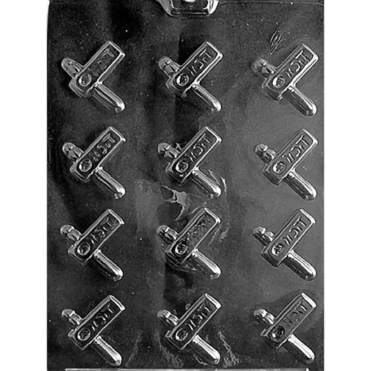 Clear plastic chocolate mold with 12 small Purim-themed cavities shaped like handheld noisemakers with a short handle and raised design details.