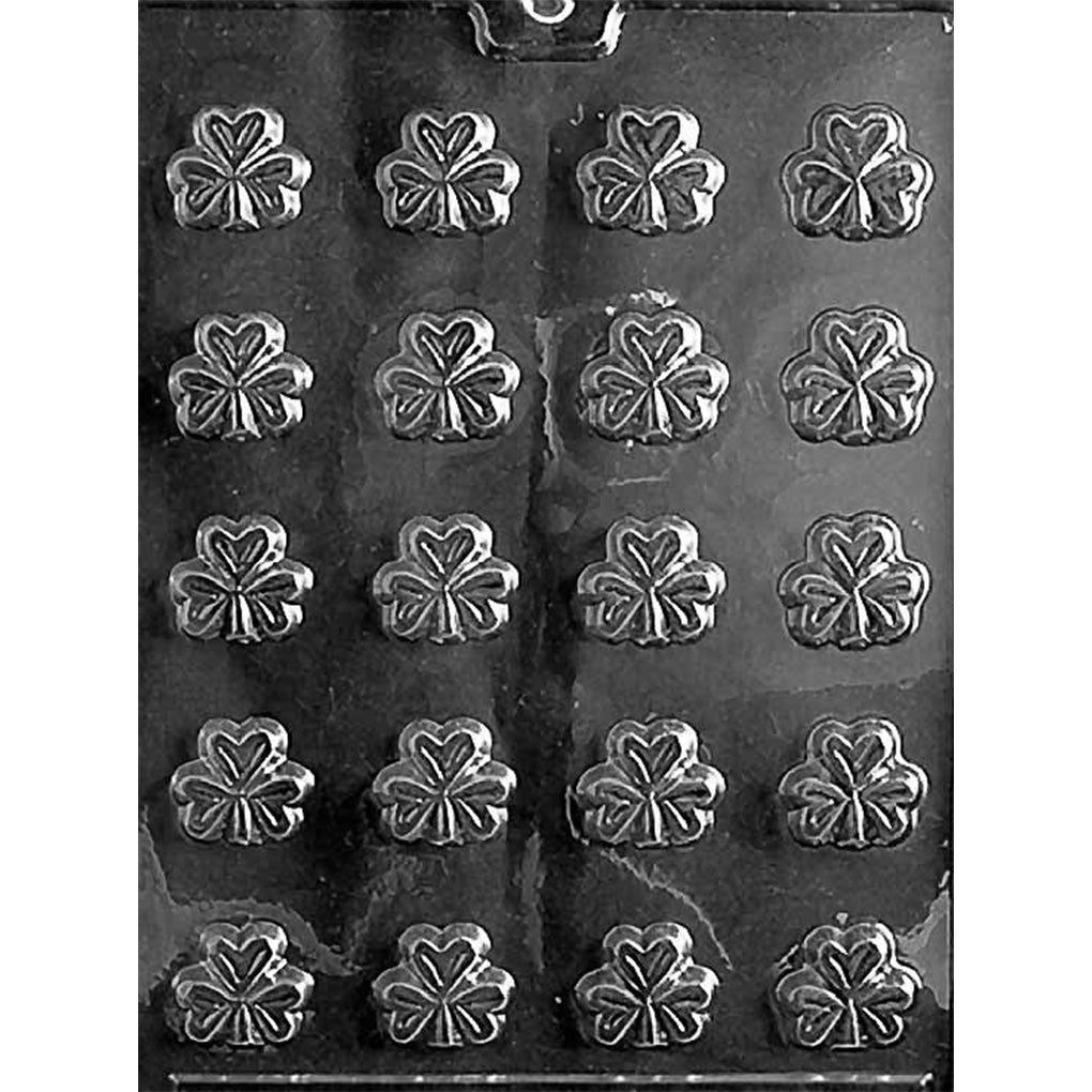 Bite size shamrocks chocolate mold with twenty small shamrock cavities arranged in rows, each shamrock featuring raised leaf and heart-like petal detail in clear plastic.
