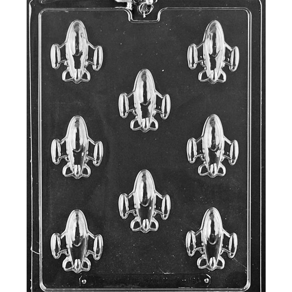 Plastic chocolate mold with eight small spaceship-shaped cavities on a rectangular sheet.