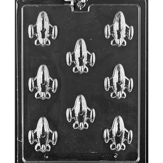 Plastic chocolate mold with eight small spaceship-shaped cavities on a rectangular sheet.