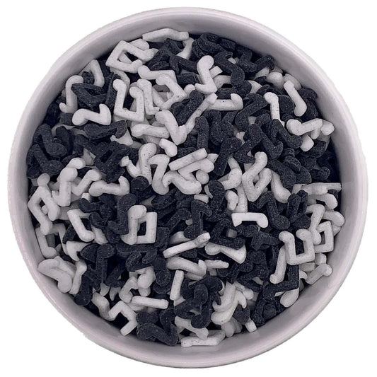 Bowl filled with black and white music note sprinkles, edible quins for decorating cupcakes, cakes, and cookies for music-themed parties